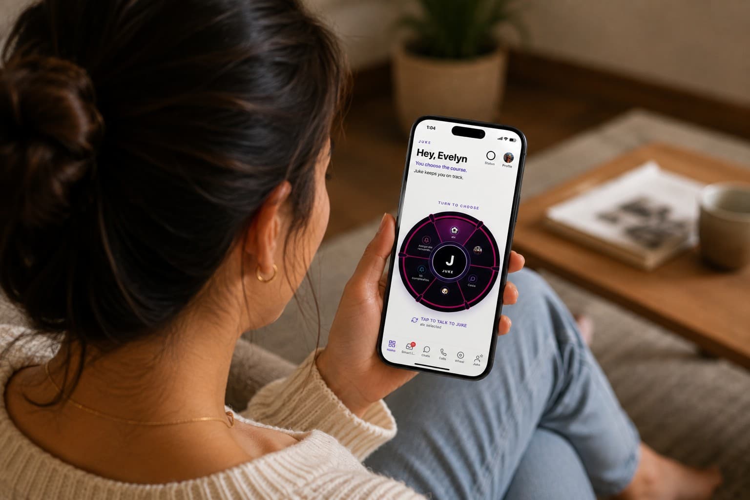 A woman relaxing on her couch, checking the Juke Wheel on her phone.